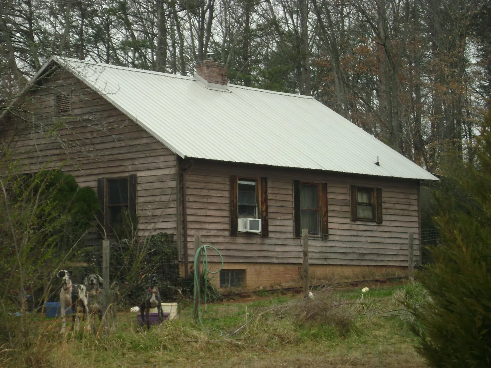 White metal roof on an old wood sided farmhouse, from a Metal Roof Installation job in Sheldon
